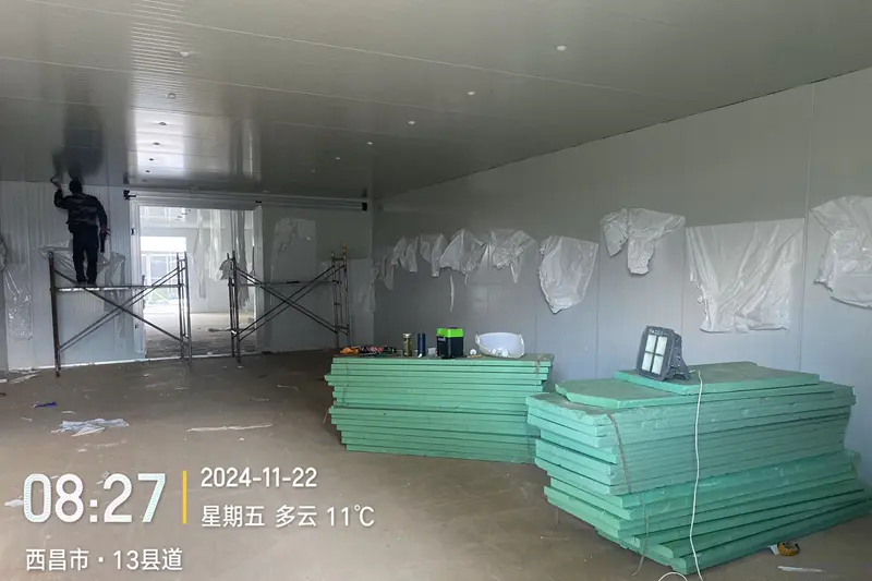 Workers carrying out roof sealing and finishing work on‑site