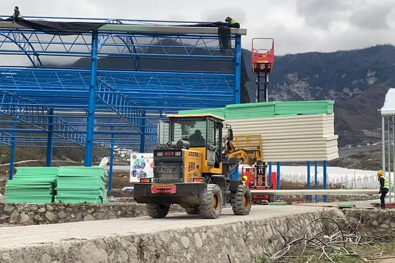 Arrival and unloading of cold‑storage insulation panels at Liangshan blueberry base site
