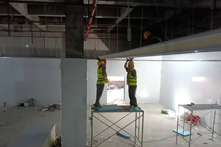 Workers installing cold storage panels