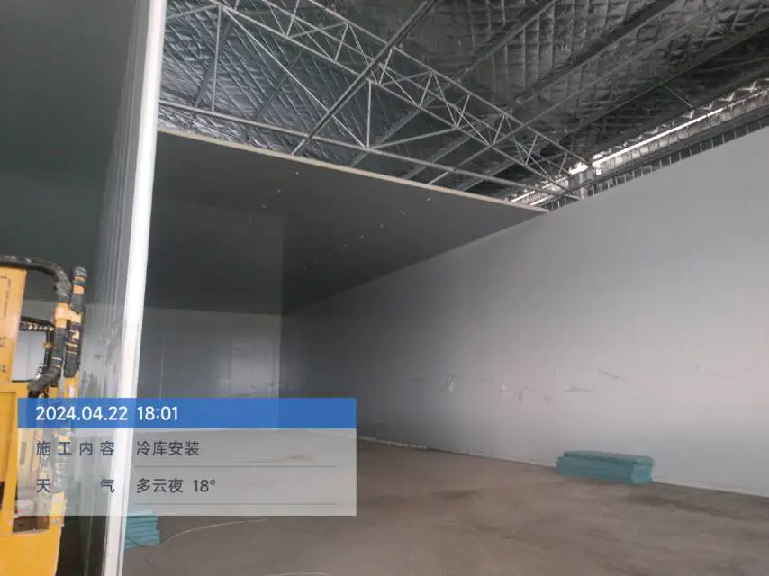 Workers installing cold storage panels