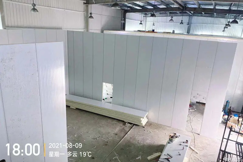 Workers are installing cold storage panels