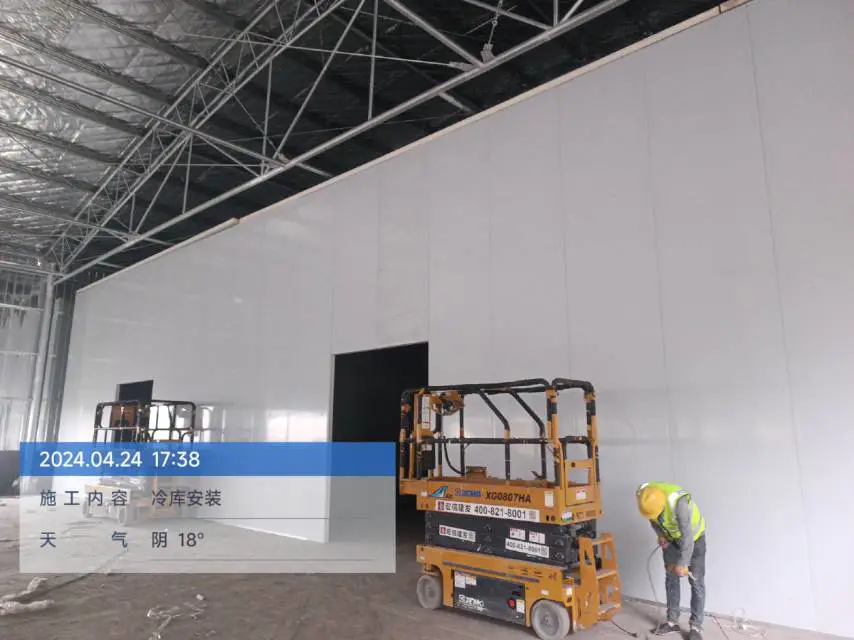 Workers installing cold storage panels