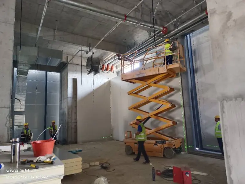 Workers installing cold storage panels