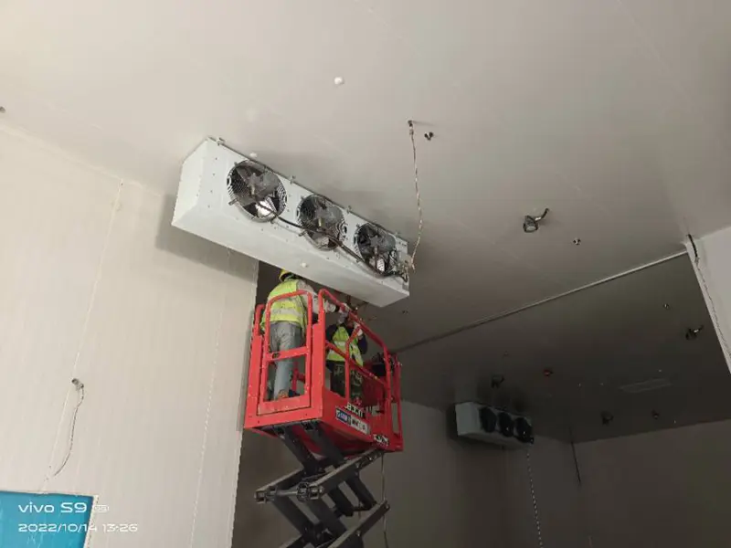 Workers installing air coolers