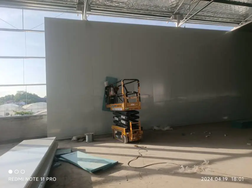 Workers installing cold storage panels