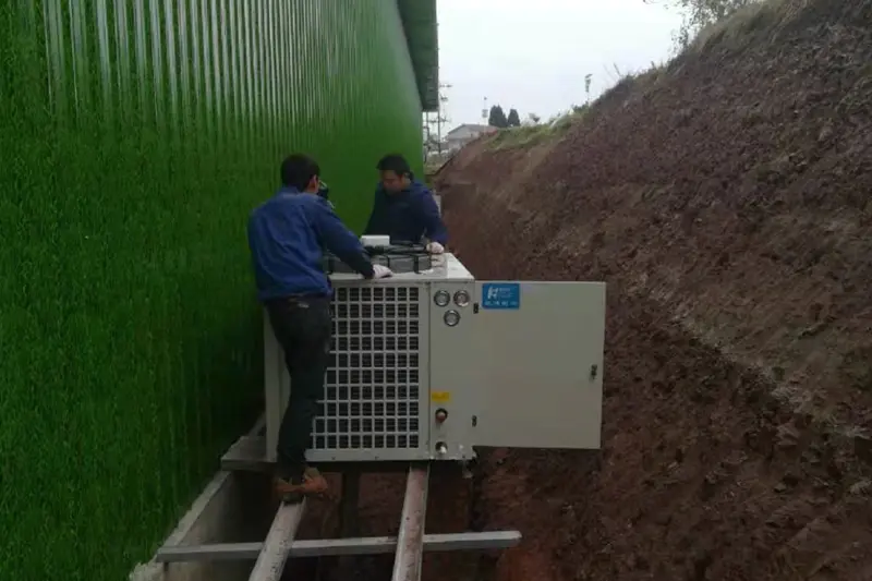 Workers installing refrigeration units