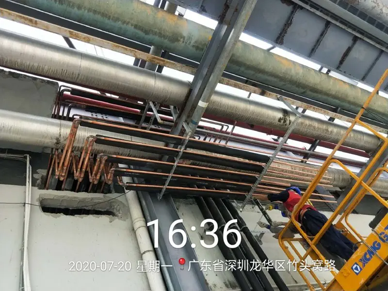 Workers are welding copper pipes