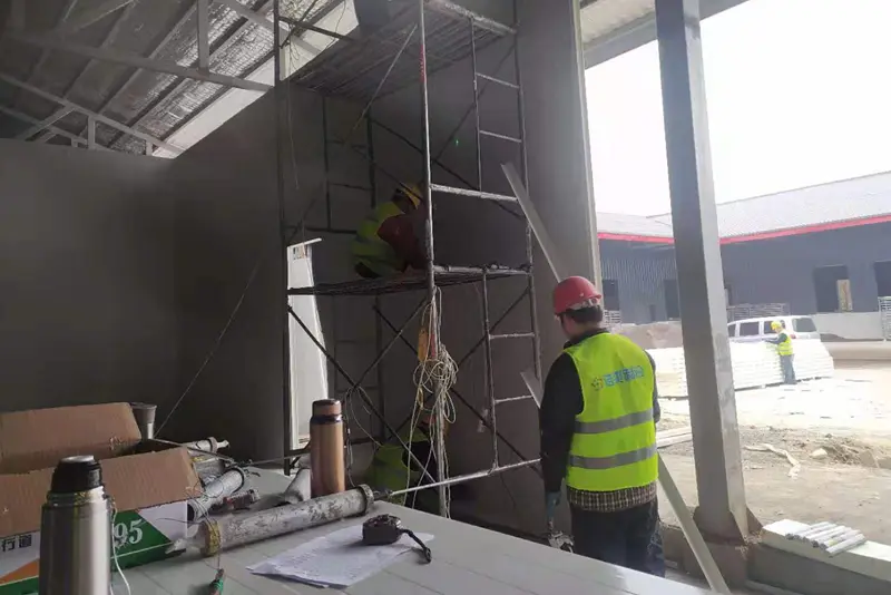 Workers are installing cold storage panels