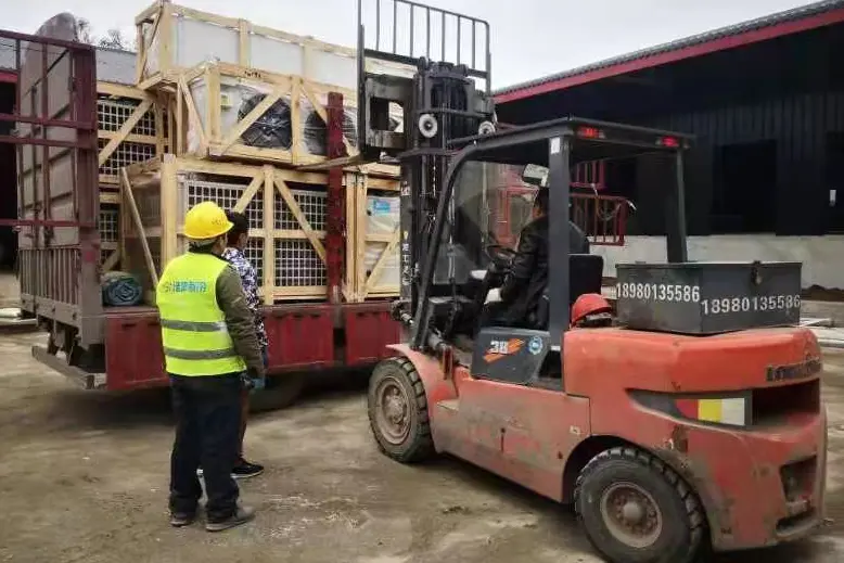 Workers are unloading the refrigeration unit