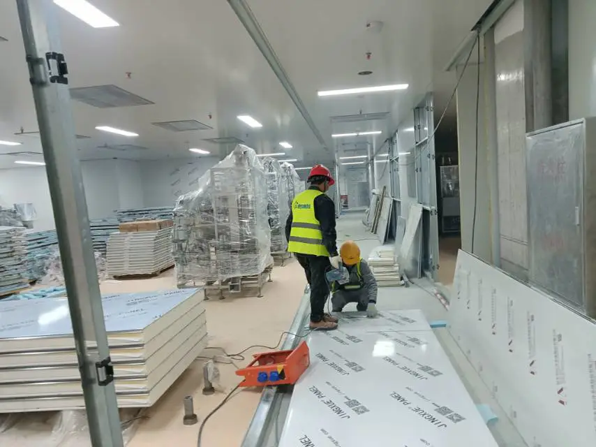 Workers are installing cold storage panels