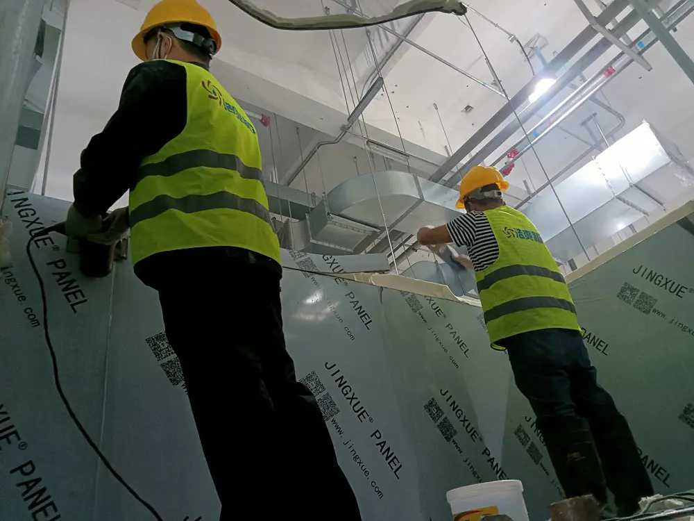 Workers are installing cold storage panels