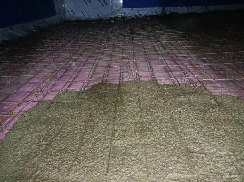 Concrete is being poured on the ground.