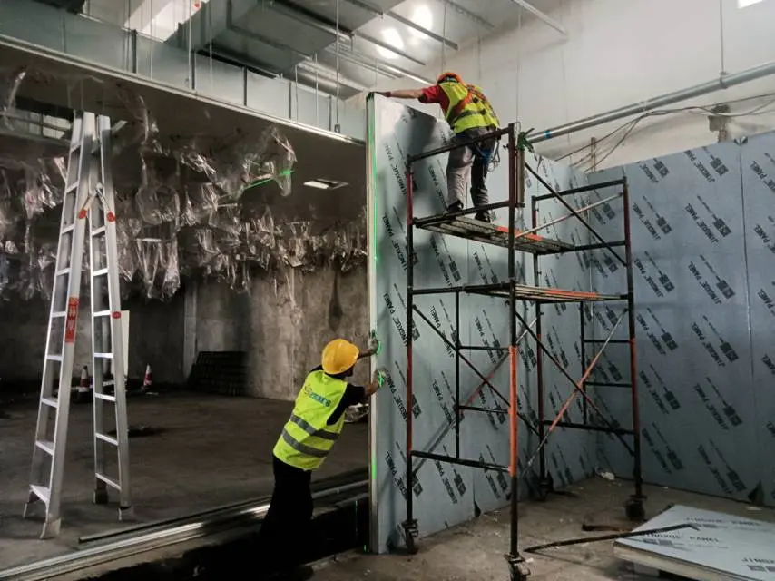 Workers are installing cold storage panels