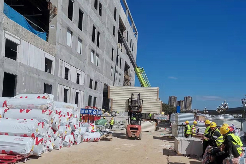 Workers are hoisting cold storage panels